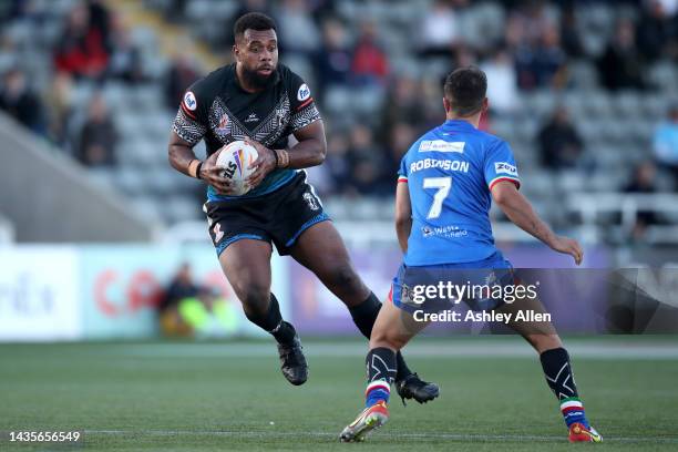 Ben Nakabuwai of Fiji gets passed Radean Robinson of Italy during the Rugby League World Cup 2021 Pool B match between Fiji and Italy at Kingston...