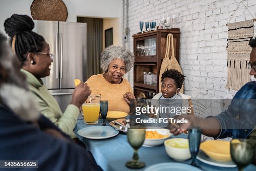 Family talking and eating during the lunch at home