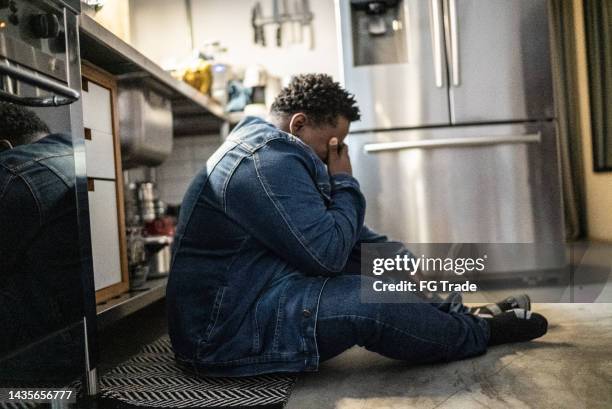 sad mid adult man in the kitchen at home - obesity imagens e fotografias de stock