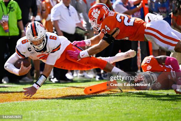 Garrett Shrader of the Syracuse Orange dives into the end zone for a touchdown against Tyler Venables of the Clemson Tigers in the second quarter at...