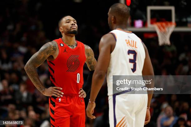 Damian Lillard of the Portland Trail Blazers looks on against Chris Paul of the Phoenix Suns in overtime at Moda Center on October 21, 2022 in...