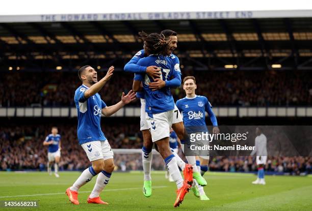 Dwight McNeil of Everton celebrates with teammate Alex Iwobi after scoring their team's third goal during the Premier League match between Everton FC...