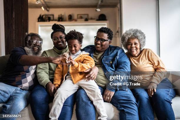 portrait of a family in the living room at home - grandmas living room stockfoto's en -beelden