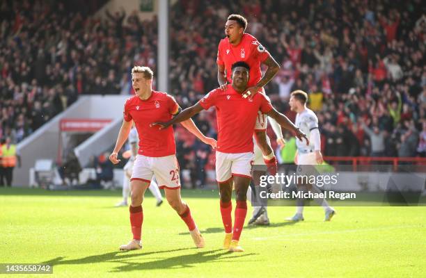 Taiwo Awoniyi of Nottingham Forest celebrates with teammates Ryan Yates and Jesse Lingard after scoring their team's first goal during the Premier...