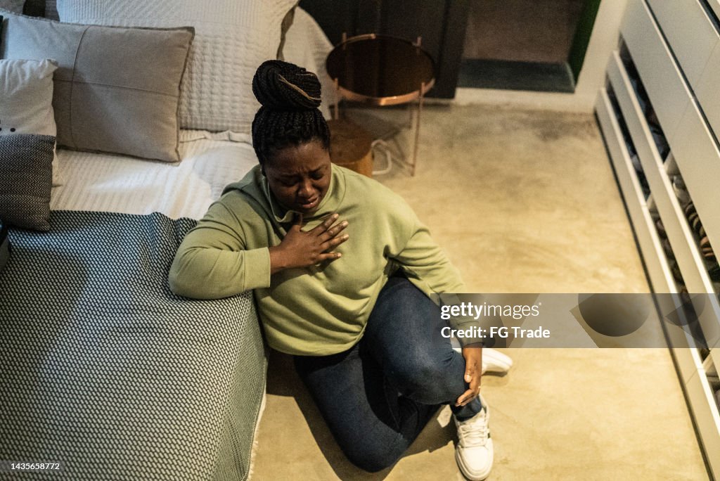 Worried mid adult woman in the bedroom at home