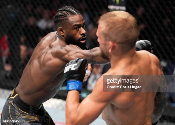 Aljamain Sterling punches TJ Dillashaw in their UFC bantamweight championship fight during the UFC 280 event at Etihad Arena on October 22, 2022 in...
