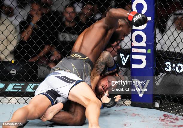 Aljamain Sterling punches TJ Dillashaw in their UFC bantamweight championship fight during the UFC 280 event at Etihad Arena on October 22, 2022 in...