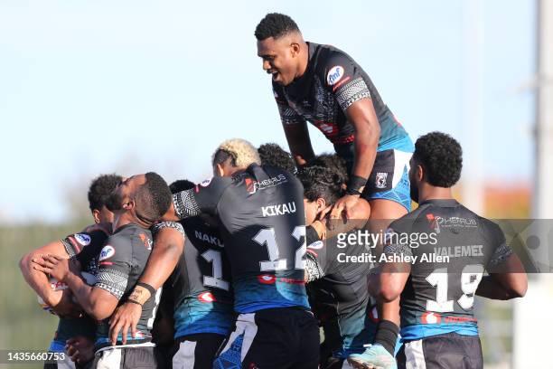 Fiji players celebrate after teammate Apisai Koroisau scores a try during the Rugby League World Cup 2021 Pool B match between Fiji and Italy at...