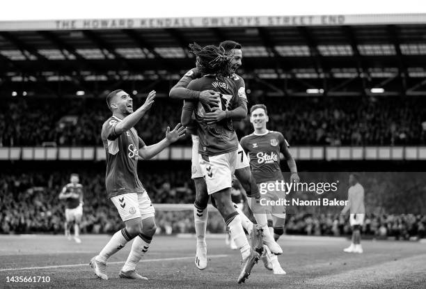 Dwight McNeil of Everton celebrates with teammate Alex Iwobi after scoring their team's third goal during the Premier League match between Everton FC...