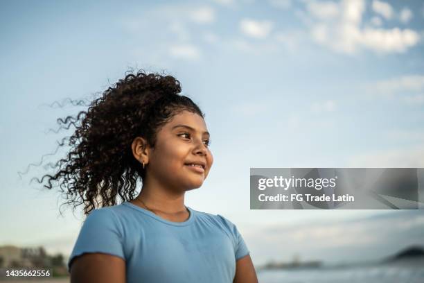girl contemplating at the beach - anticipation stock pictures, royalty-free photos & images