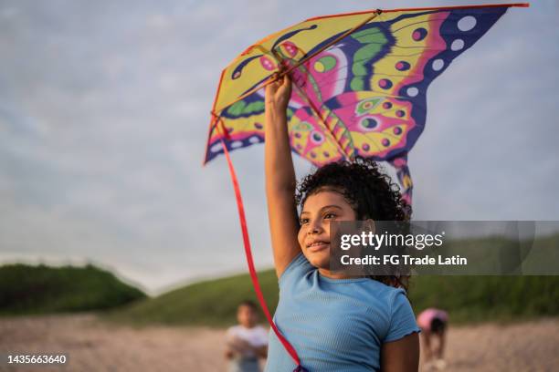 girl holding a kite while contemplating at the beach - 8 muses stock pictures, royalty-free photos & images