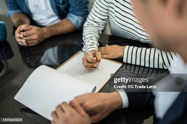 close-up of hand filling paperwork at home - allowing stockfoto's en -beelden