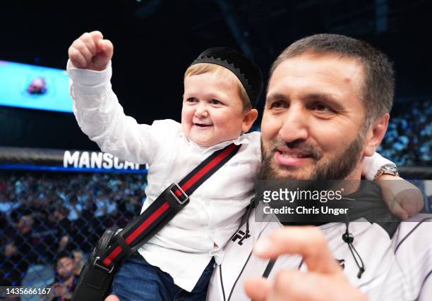Hasbulla Magomedov is seen in the Octagon celebrating after Islam Makhachev's victory over Charles Oliveira in their UFC lightweight championship...