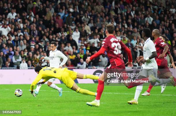 Lucas Vazquez of Real Madrid scores their team's second goal past Yassine Bounou of Sevilla FC during the LaLiga Santander match between Real Madrid...