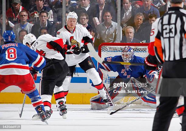 Henrik Lundqvist of the New York Rangers protects the net against Chris Neil of the Ottawa Senators in Game Seven of the Eastern Conference...