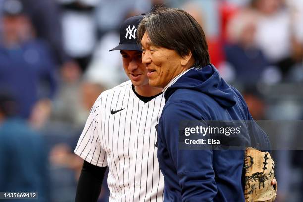 Former New York Yankees outfielder Hideki Matsui is hugged by Kyle Higashioka after his ceremonial first pitch prior to game three of the American...