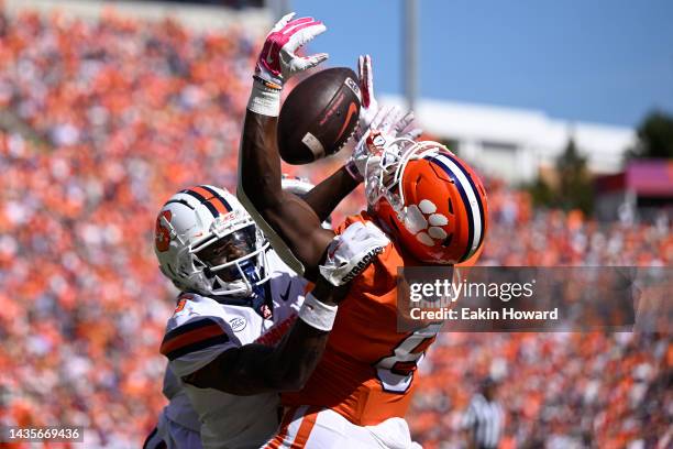 Darian Chestnut and Alijah Clark of the Syracuse Orange break up a pass intended for Adam Randall of the Clemson Tigers in the second quarter at...