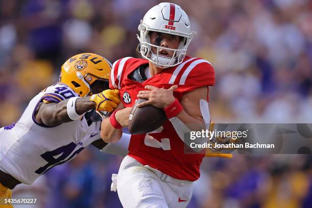 Jaxson Dart of the Mississippi Rebels is tackled by Harold Perkins Jr. #40 of the LSU Tigers during the first half at Tiger Stadium on October 22,...