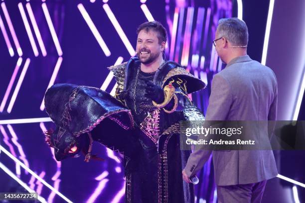 Felix von Jascheroff unmasked aka "Die Black Mamba" and host Matthias Opdenhoevel seen onstage during the 4th show of "The Masked Singer" on October...