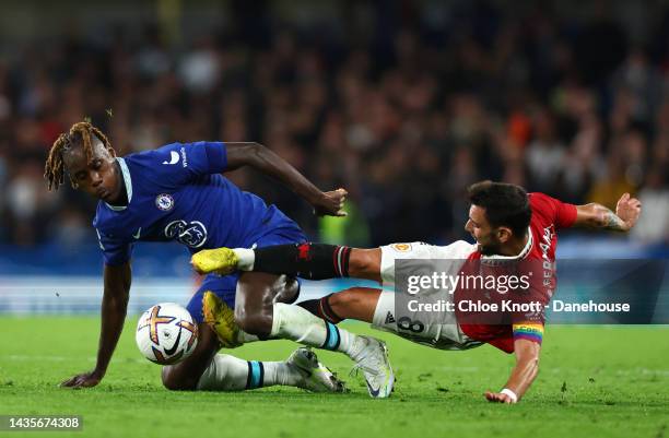 Bruno Fernandes of Manchester United and Trevoh Chalobah of Chelsea FC battle for the ball during the Premier League match between Chelsea FC and...