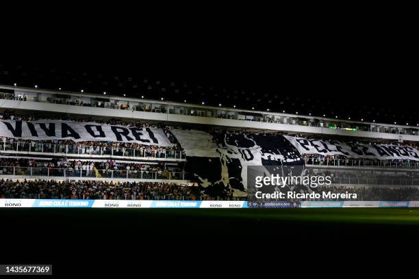 Fans of Santos display a banner for Pele's 82nd birthday prior the match between Santos and Corinthians as part of Brasileirao Series A 2022 at Vila...