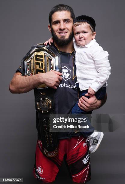 Islam Makhachev of Russia poses for a portrait with Hasbulla Magomedov after winning the UFC lightweight championship during the UFC 280 event at...