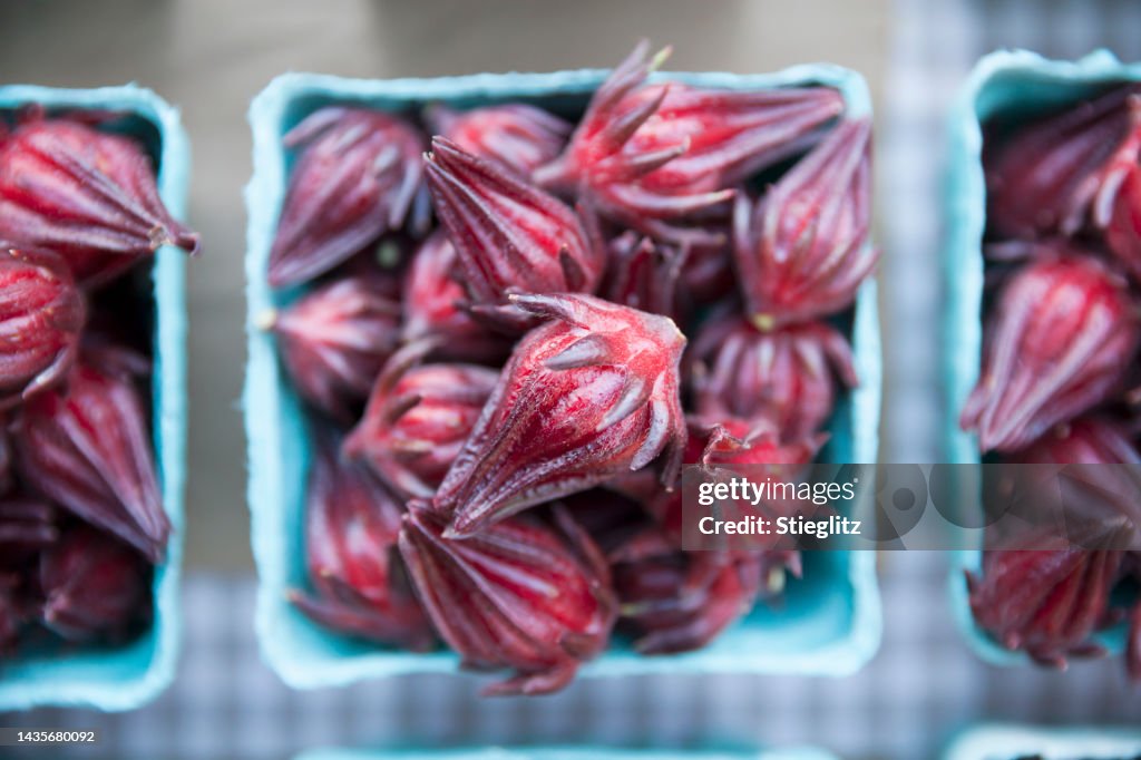 Roselle hibiscus flowers (roselle calyx, hibiscus sabdariffa, Jamaican sorrel, or red sorrel) at a farmer's market.
