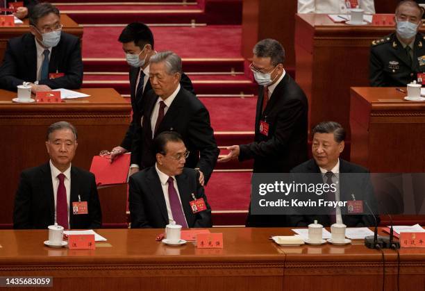 Chinese President Xi Jinping and Premier Li Keqiang, left, and Politburo member Wang Yang look on as former President Hu Jintao, centre, speaks to...