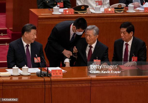 Chinese President Xi Jinping, bottom left, Li Zhanshu, and Wang Huning,right, look on as former President Hu Jintao, centre, is helped to leave early...