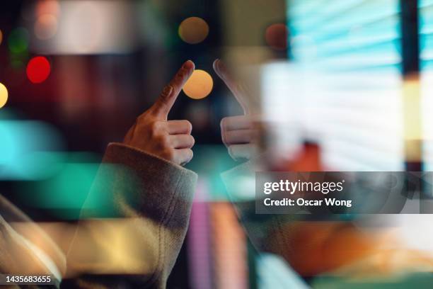 close-up of female finger touching on digital screen - touching screen photos et images de collection