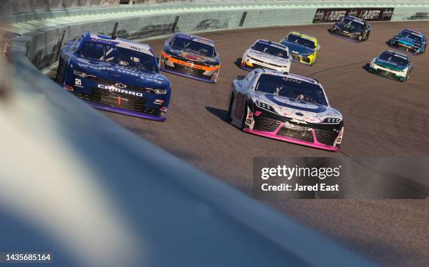 Austin Hill, driver of the United Rentals Chevrolet, and Trevor Bayne, driver of the Devotion Nutrition Toyota, race during the NASCAR Xfinity Series...