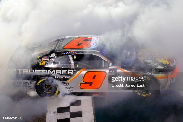 Noah Gragson, driver of the Bass Pro Shops/TrueTimber/BRCC Chevrolet, celebrates with a burnout after winning the NASCAR Xfinity Series Contender...