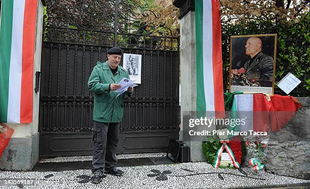 Man attends a commemoration ceremony for the death of Italian dictator Benito Mussolini and his mistress, Claretta Petacci in front of a headstone of...