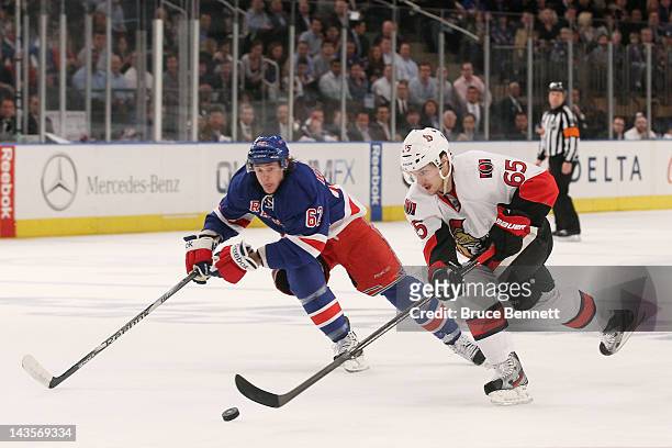Carl Hagelin of the New York Rangers and Erik Karlsson of the Ottawa Senators vie for the puck in Game Seven of the Eastern Conference Quarterfinals...