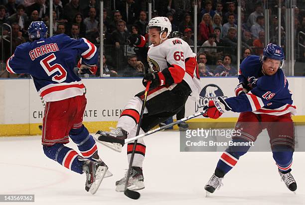 Dan Girardi of the New York Rangers and Erik Karlsson of the Ottawa Senators collide as Brad Richards of the New York Rangers looks on in Game Seven...