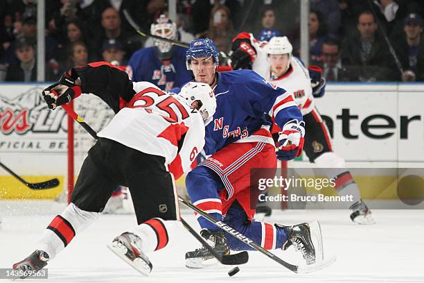 Erik Karlsson of the Ottawa Senators and Chris Kreider of the New York Rangers vie for the puck in Game Seven of the Eastern Conference Quarterfinals...