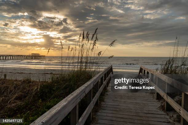 sunrise at myrtle beach state park in south carolina along the atlantic ocean with pier - myrtle beach stock pictures, royalty-free photos & images