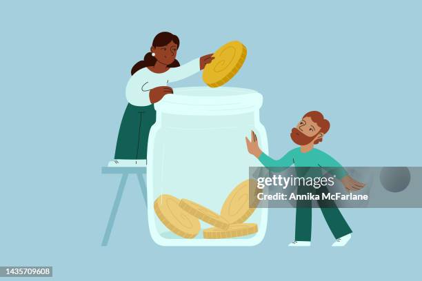 a mixed race couple saves money and puts coins into savings jar - couple saving piggy bank stock illustrations