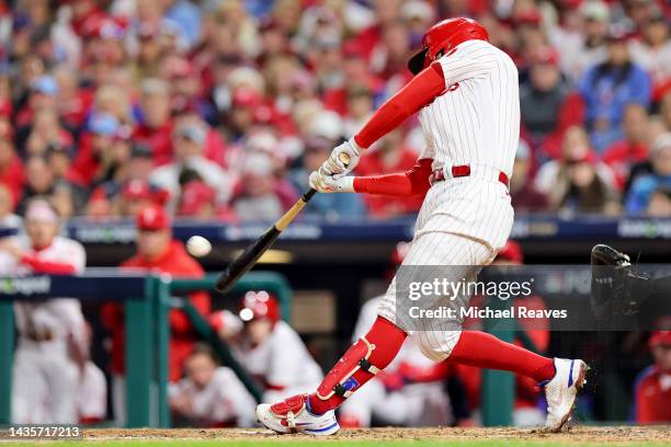 Rhys Hoskins of the Philadelphia Phillies hits a two-run home run against the San Diego Padres during the fifth inning in game four of the National...