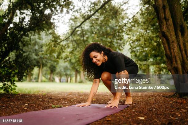 young woman exercising on a public park,germany - yoga germany stockfoto's en -beelden