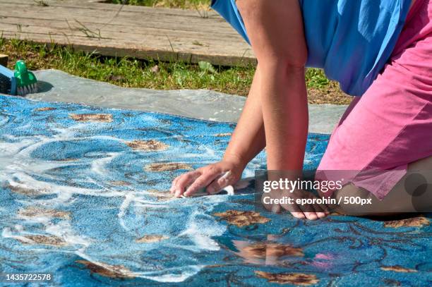 soaping the carpet,washing the carpet on the street - wet carpet stock pictures, royalty-free photos & images