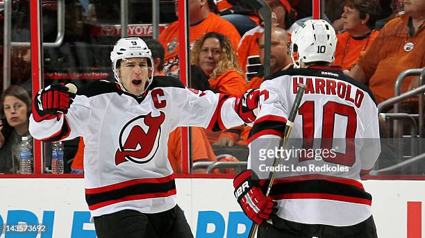 Zach Parise of the New Jersey Devils celebrates his goal against the Philadelphia Flyers at 3:16 of the first period with teammate Peter Harrold in...