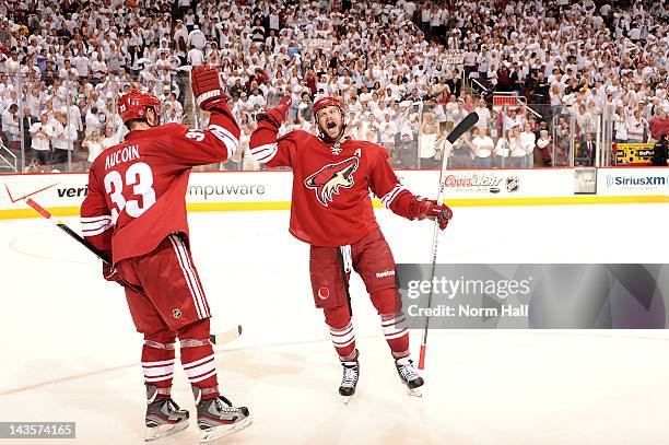 Keith Yandle and Adrian Aucoin of the Phoenix Coyotes celebrate after an overtime victory against the Nashville Predators in Game One of the Western...