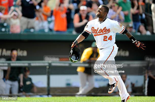 Wilson Betemit of the Baltimore Orioles celebrates after hitting the game-winning home run in the ninth inning against the Oakland Athletics at...