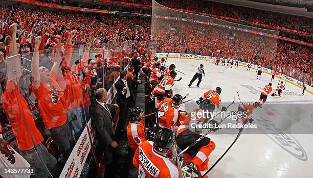 Members of the Philadelphia Flyers celebrate after Danny Briere scored the game-winning goal in overtime against the New Jersey Devils in Game One of...