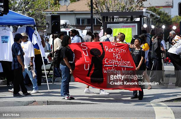 People hold a rally at the intersection of Florence and Normandie Avenuesin South Los Angeles on April 29, 2012 in Los Angeles, California. This...