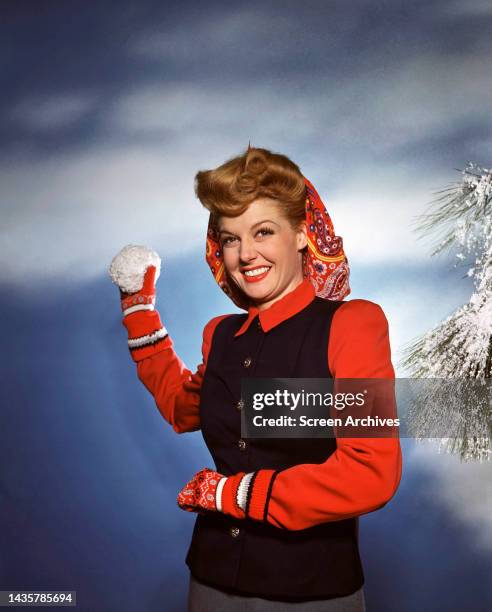 Ann Sheridan playfully about to throw snowball in a studio publicity portrait circa 1945.