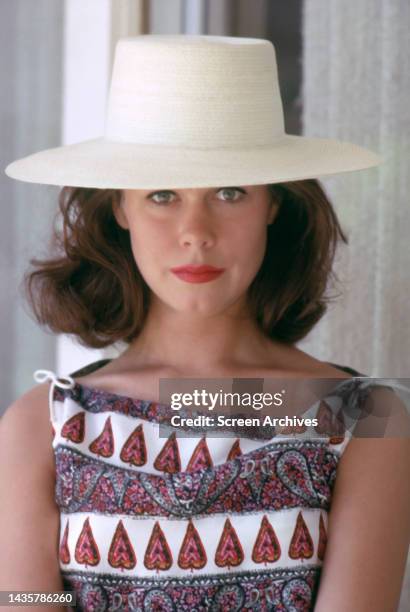 Elizabeth Montgomery posing in straw hat for a publicity photo circa 1962.