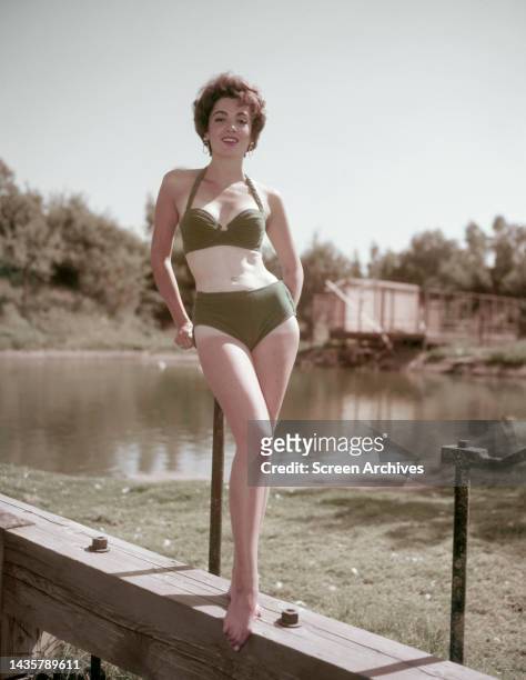Linda Cristal barefoot glamour pose in bikini for the 1958 movie The Fiend Who Walked the West.