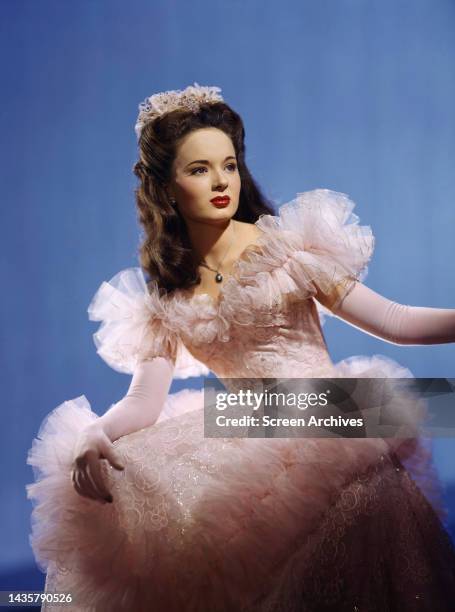 Ann Blyth vivid color publicity portrait wearing elegant white dress circa 1952.